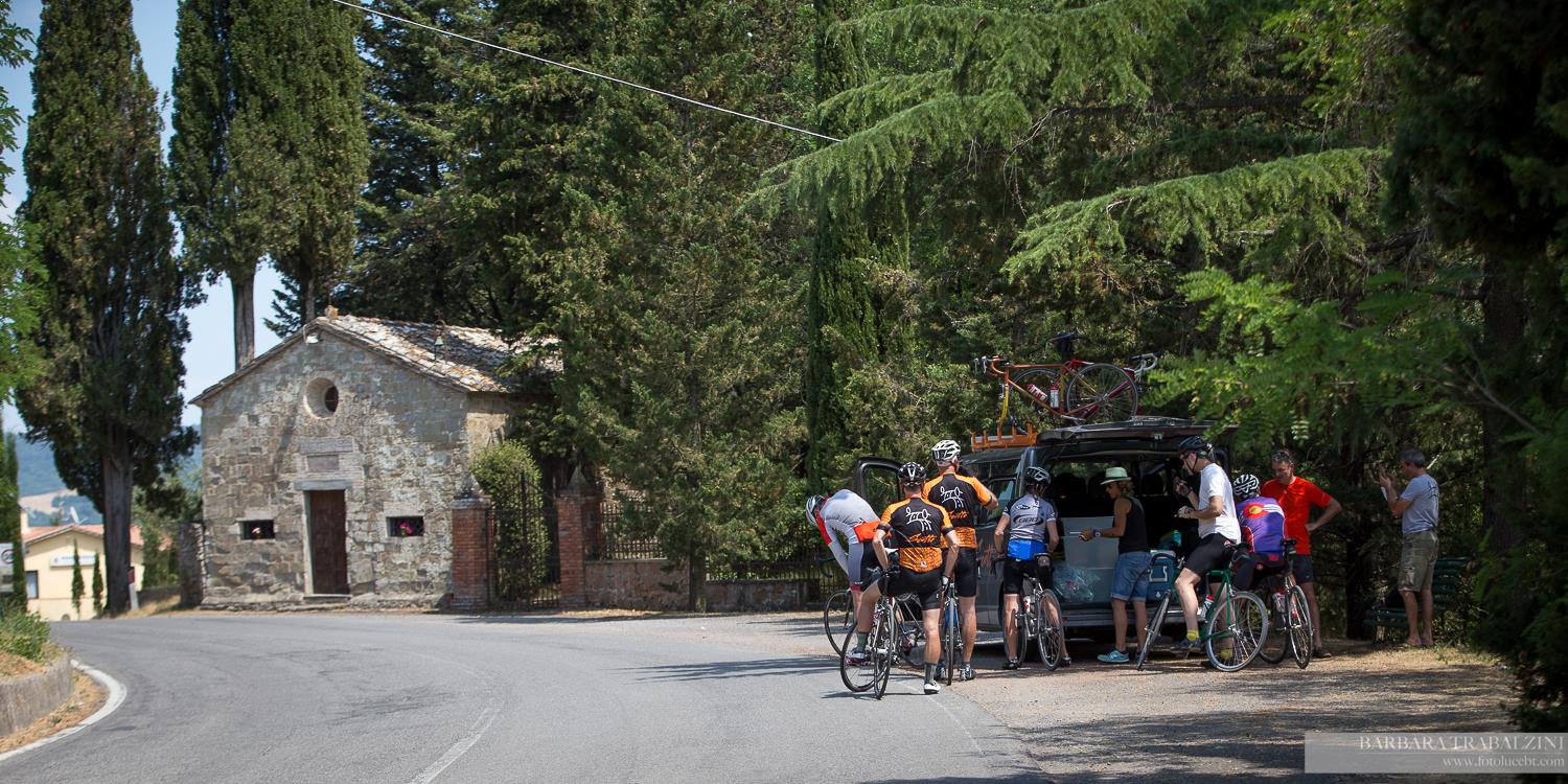 A group of cyclists beside the road in an Italian village